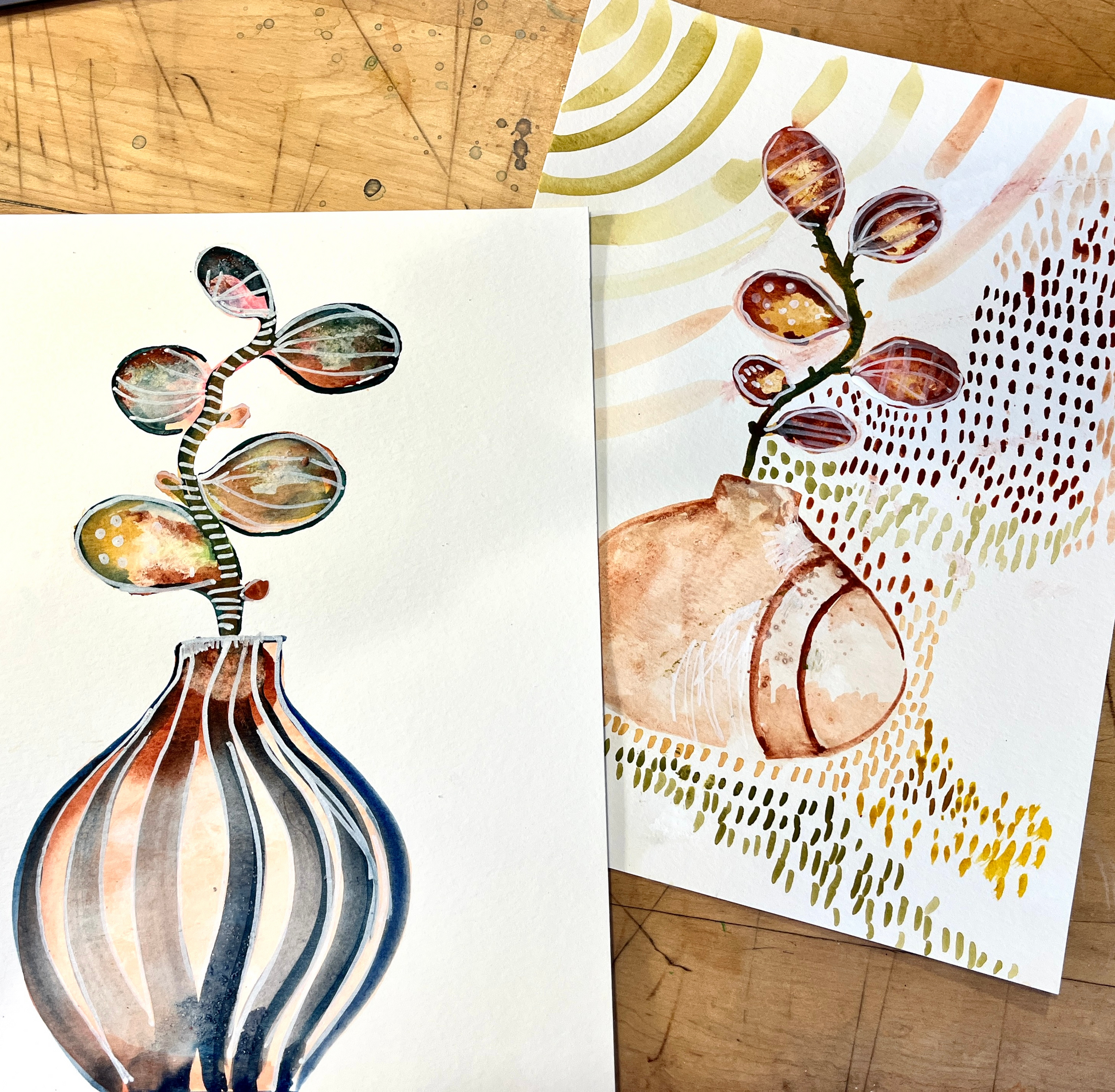 Two artistic representations of watercolor hand painted whimsical vases on a wooden surface