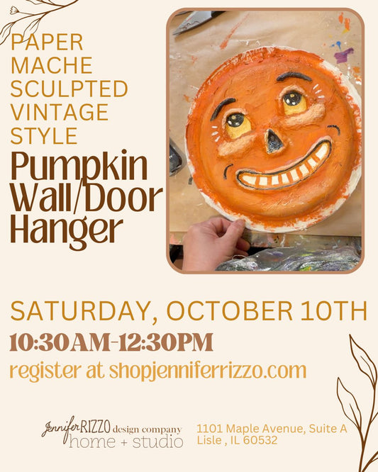 Promotional flyer for a pumpkin wall/hanger made from paper mache in a vintage style. The flyer features a photo of a hand holding a round orange pumpkin face sculpture with painted eyes and a toothy grin.